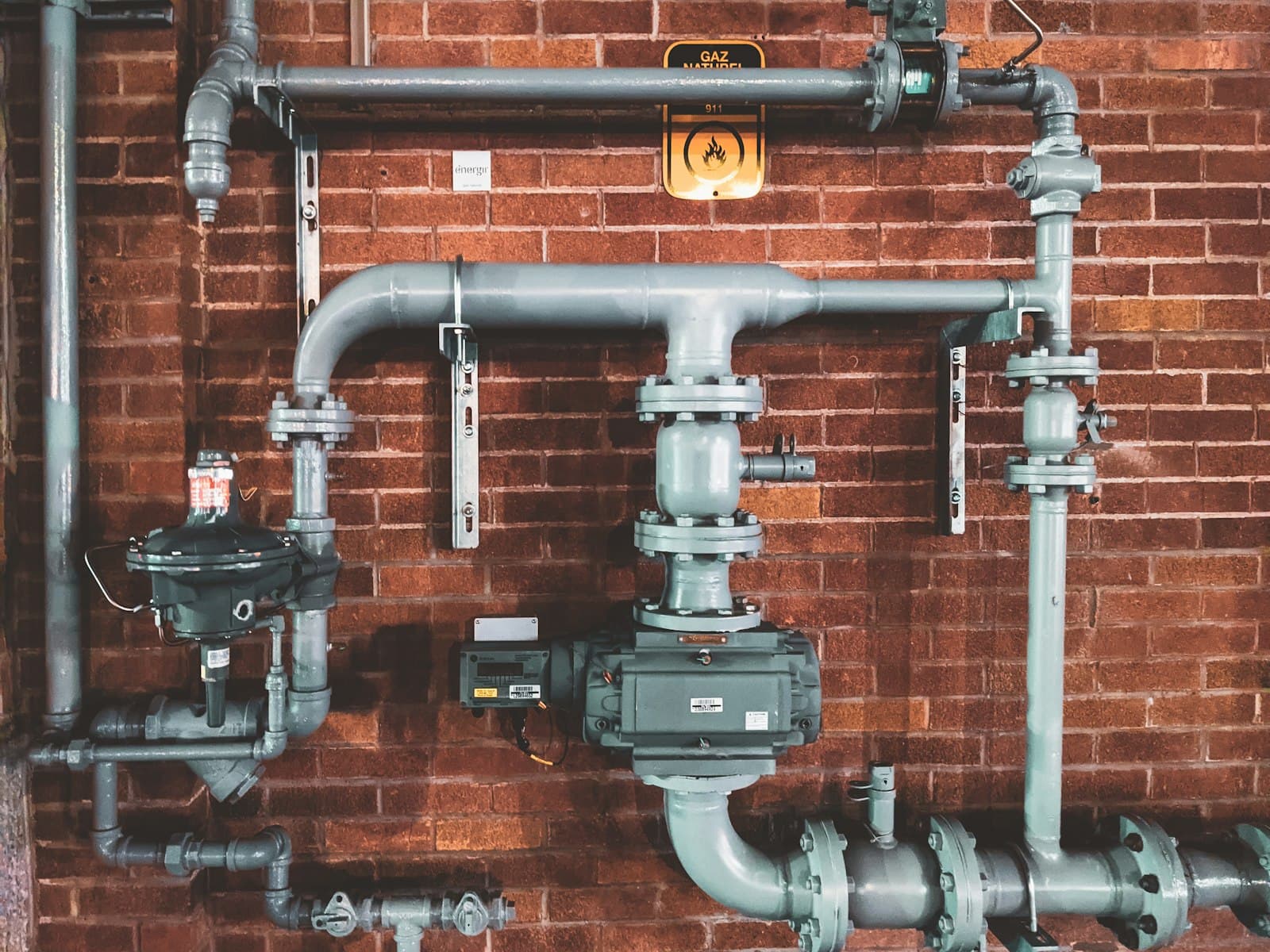 Installed pipework and valves on a finished wall