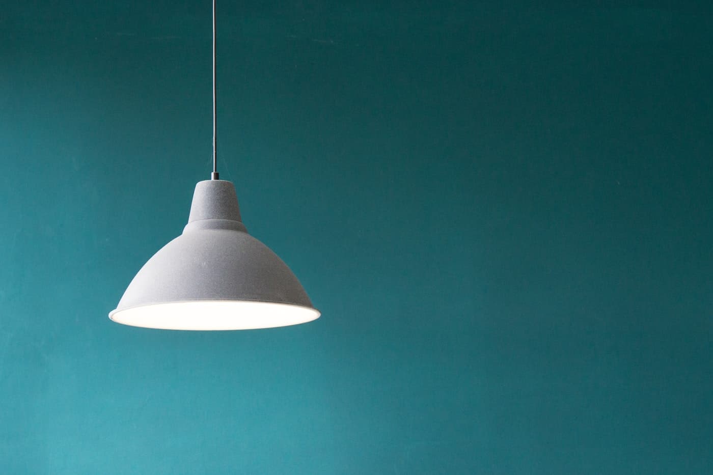 Installed outdoor-style lighting fixture on a finished wall
